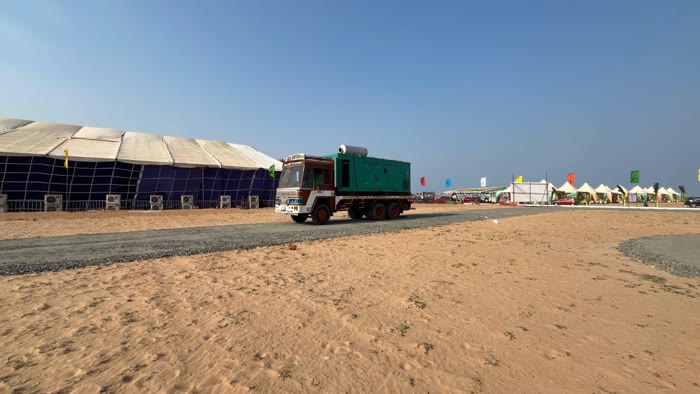 Excel Gentech generator powering a large outdoor event tent on the beach